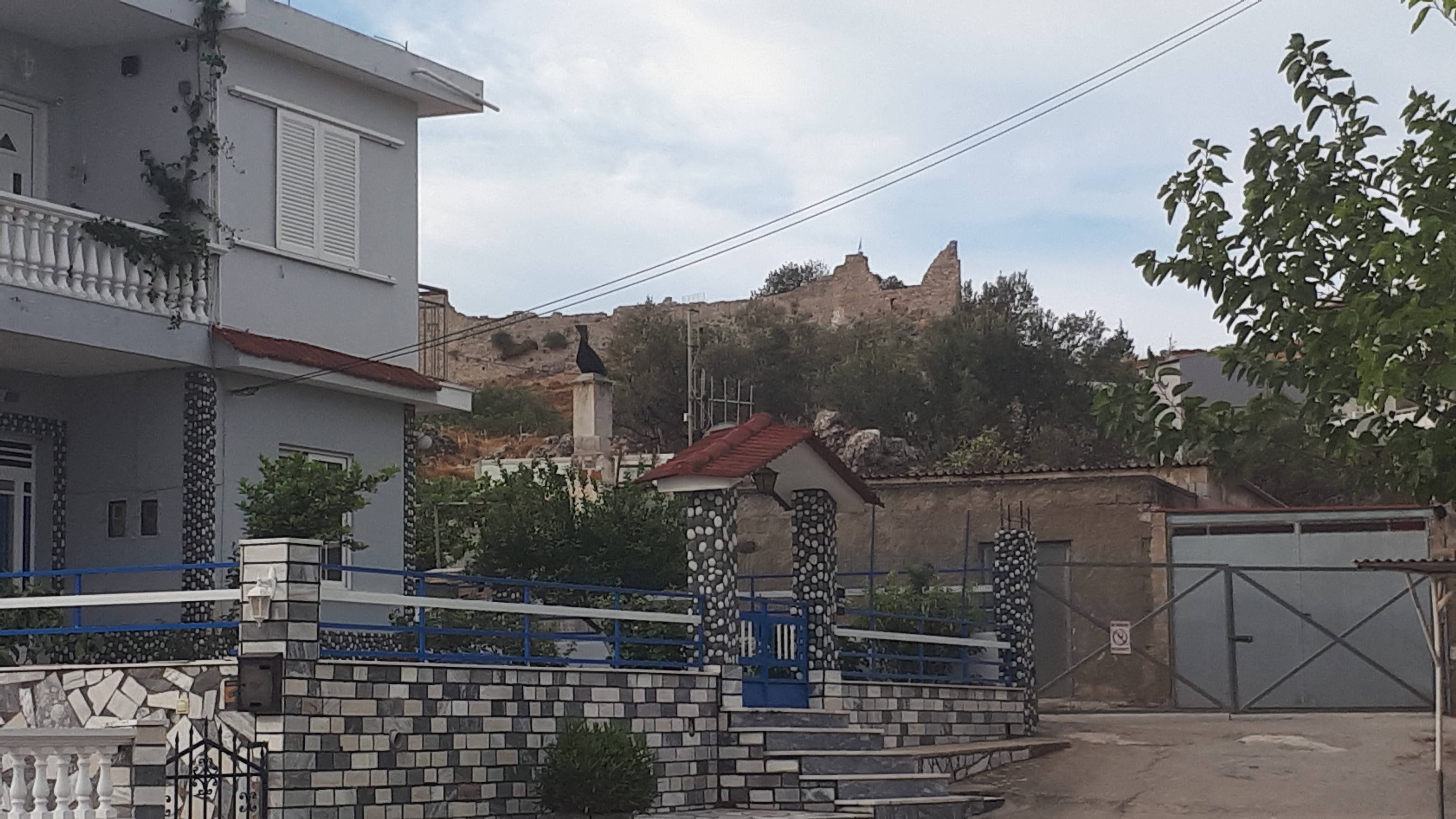 The castle is glimpsed above the houses at the edge of town