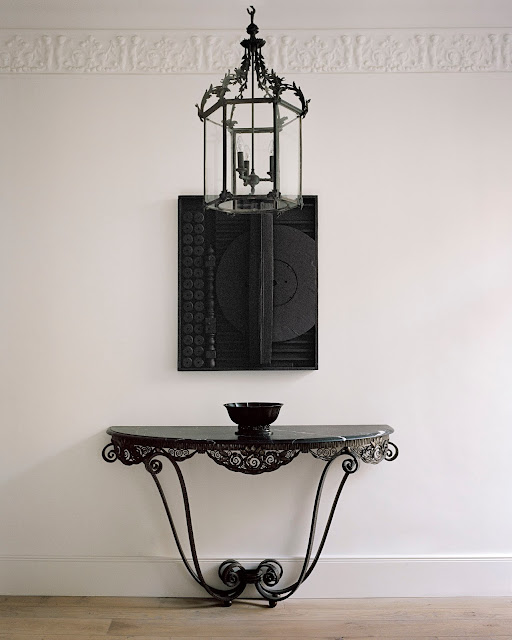black iron entry table and chandelier