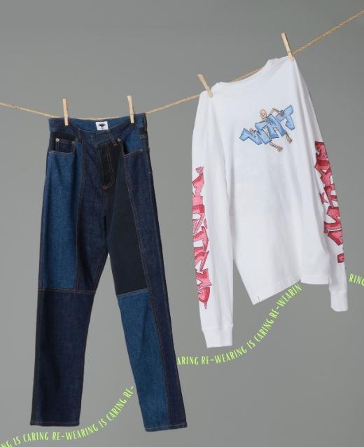 Image of jeans and long sleeve white top hanging on a washing line, underneath is green text that writes re-wearing is caring.