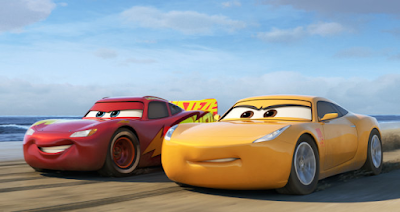 lightning mcqueen and cruz ramirez racing alongside each other on a beach