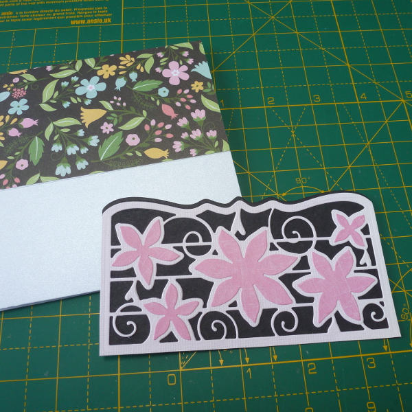 Cut the Tonic Studios die to make a pocket section for the front of the greeting card black and pink colors used