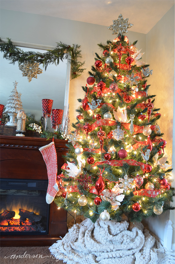 Red, gold, silver, and cream ornaments cover a Christmas tree | www.andersonandgrant.com