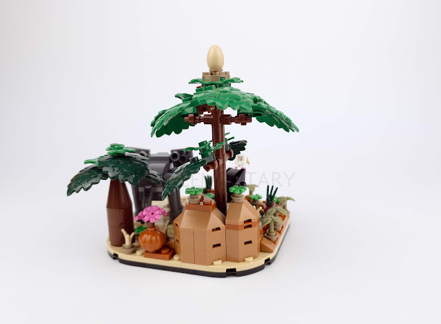 rear view of the back of 40784 African Savanna Diorama Gift with Purchase. A large rock is prominent in the foreground