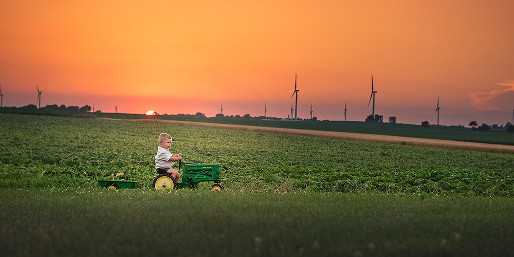toddler on a john deere tractor at sunset Shabbona IL DeKalb IL best child photographer