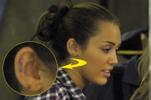 Miley Cyrus getting tattoos inked on her right ear and under her left breast