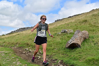 Me smiling running along a rocky path in the Yorkshire Dales.