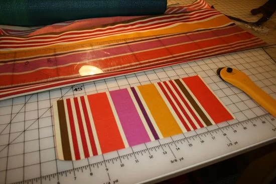 After deciding how big I wanted the pocket and which stripes I wanted to showcase, I measured the pocket fabric and sliced it to size before ironing a hemline around the edges.