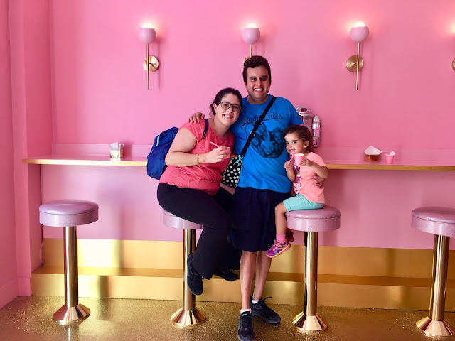 A family of three sitting at a 1950s-style diner counter 