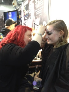 Makeup artist working on model