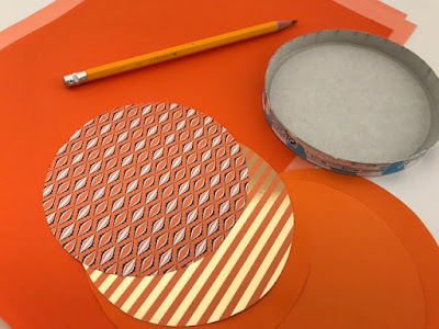 Cutting circles to make a paper pumpkin