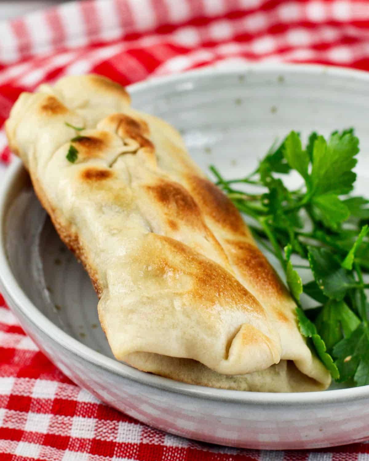 Rgaif - Moroccan Flat Bread with filling rolled up like a burrito.