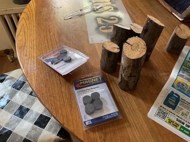 Photo of magnets and cut tree branch sections.