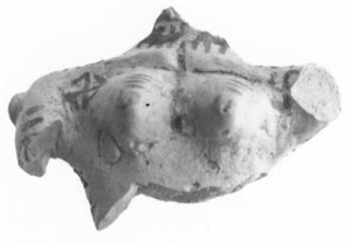 Fragment of a female figurine from Tall-e Bakun, Iran. Two swastikas.