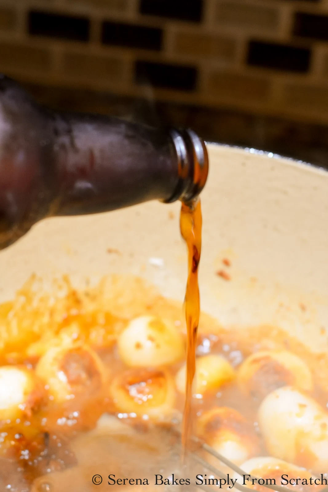 Guinness Beer being stirred into roux for Guinness Beef Stew recipe.