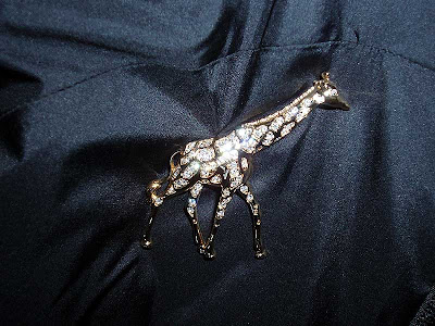 This giraffe pin is covered with Swarovski crystals.