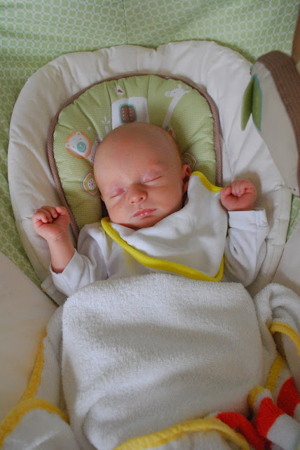 newborn baby in a gliding chair