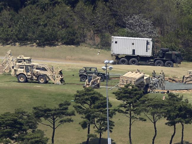US Army soldiers install their missile defense system called Terminal High-Altitude Area Defense, or THAAD, at a golf course in Seongju, South Korea.