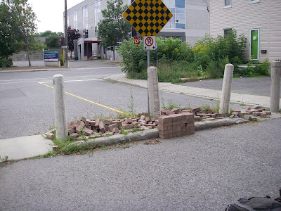 loose brick pavers in Fused Grid traffic protection on Bay Street, Ottawa