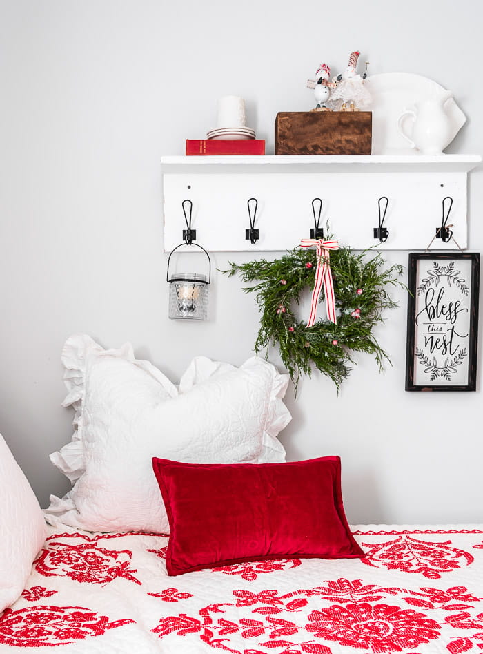 white cottage wood shelf, black hooks, red and white bedding