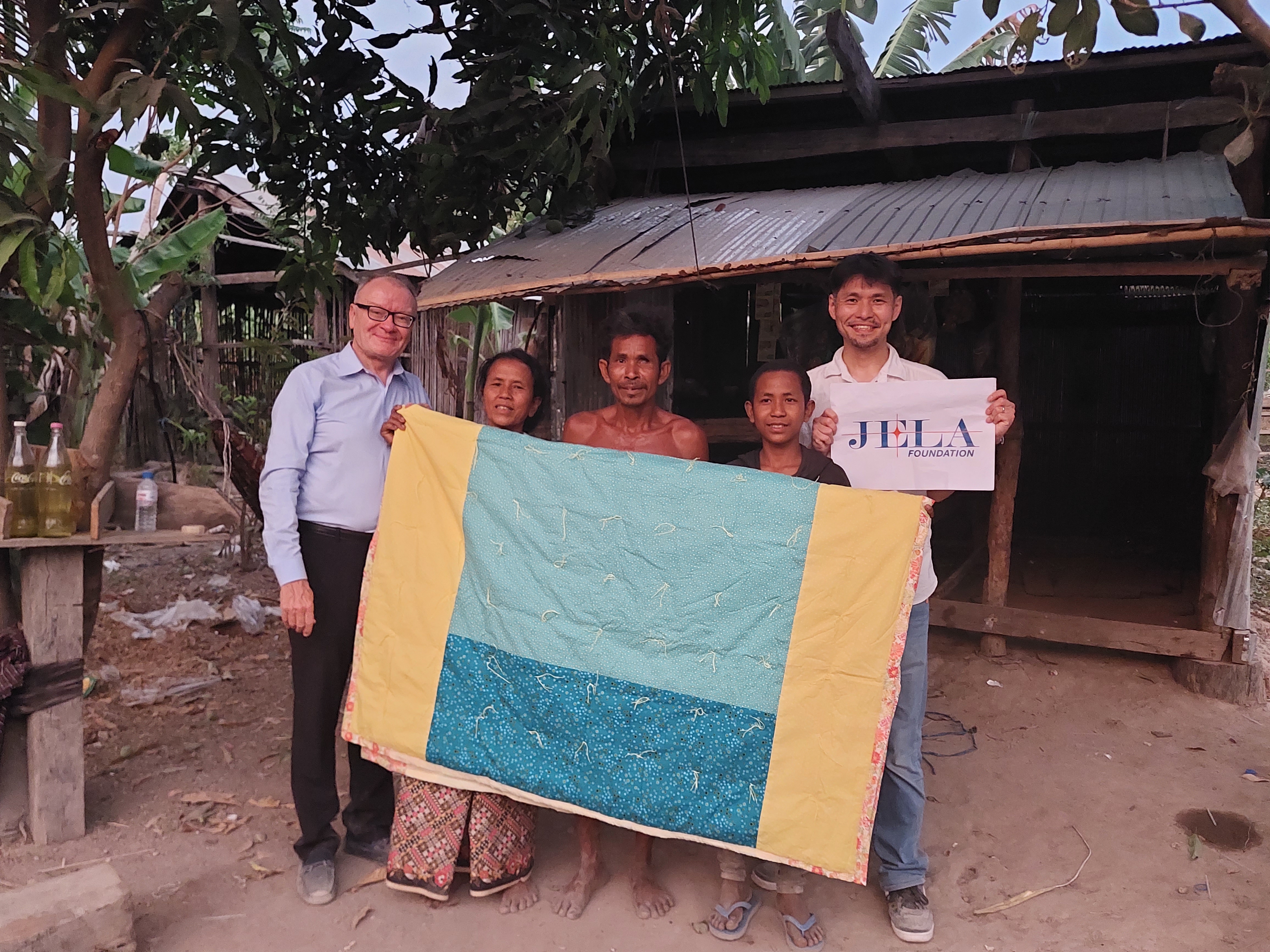 Cambodian family receives a quilt.