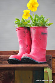 use rain boots from a thrift store for a planter