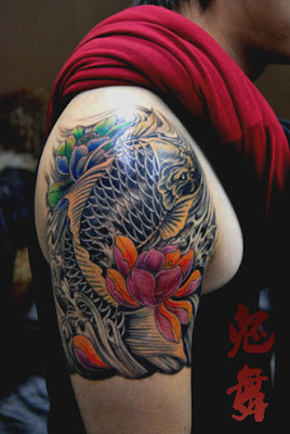 KOI fish tattoo design on the arm with a lotus flower