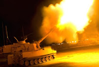 An M109A6 Paladin fires illumination rounds to expose enemy movement March 29 near Mosul, Iraq. Photo by Spc. John Crosby.