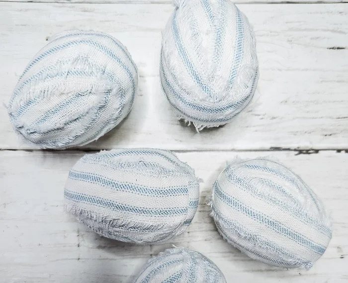 eggs wrapped in frayed ticking stripe fabric strips