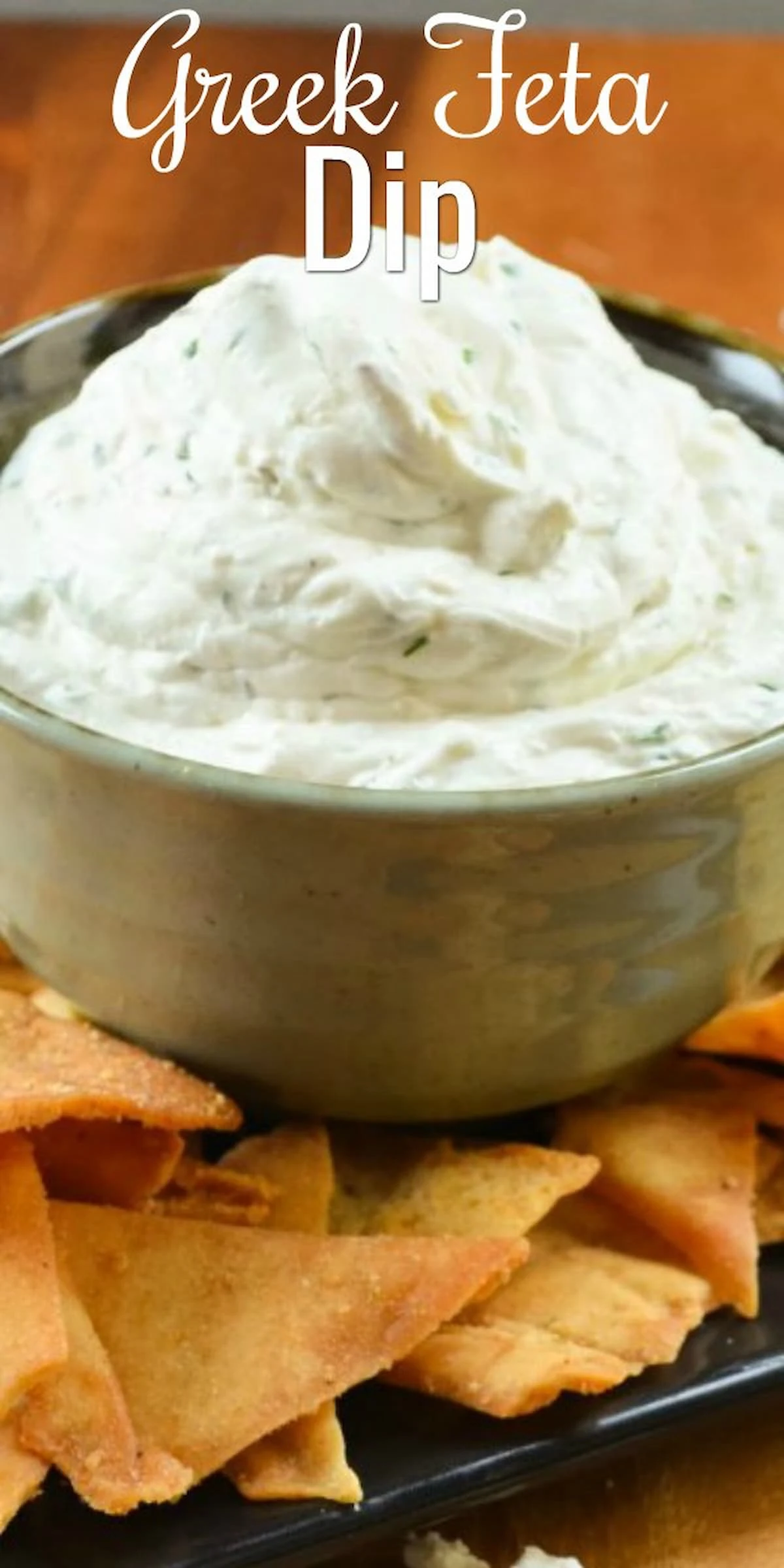 Greek Feta Dip in a bowl with pita chips around the edge.