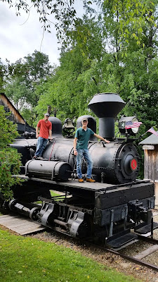 Interns stand on Shay Locomotive at PA Lumber Museum