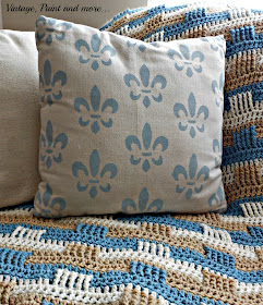 a pillow made from drop cloth fabric and stenciled in a fleur de lis design with craft paint