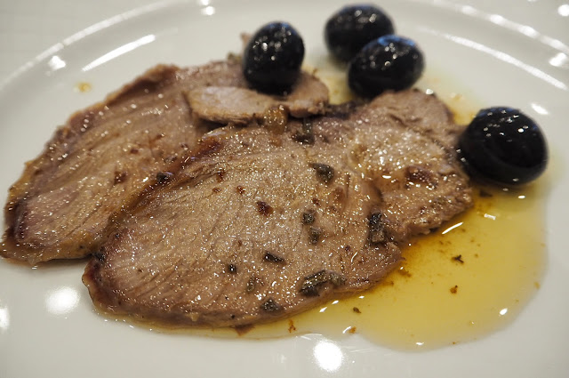 Italian wild boar served with olive oil and black olives