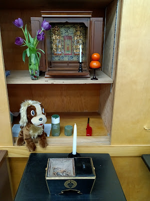 Buddhist Altar (Butsudan) with stuffed animal, flower, candle, and incense burner