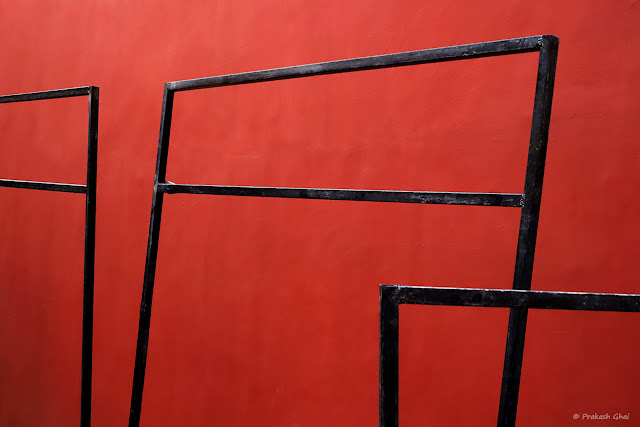 A Minimal Art Picture of Empty Black Frames against the Red Walls at Jawahar Kala Kendra Jaipur