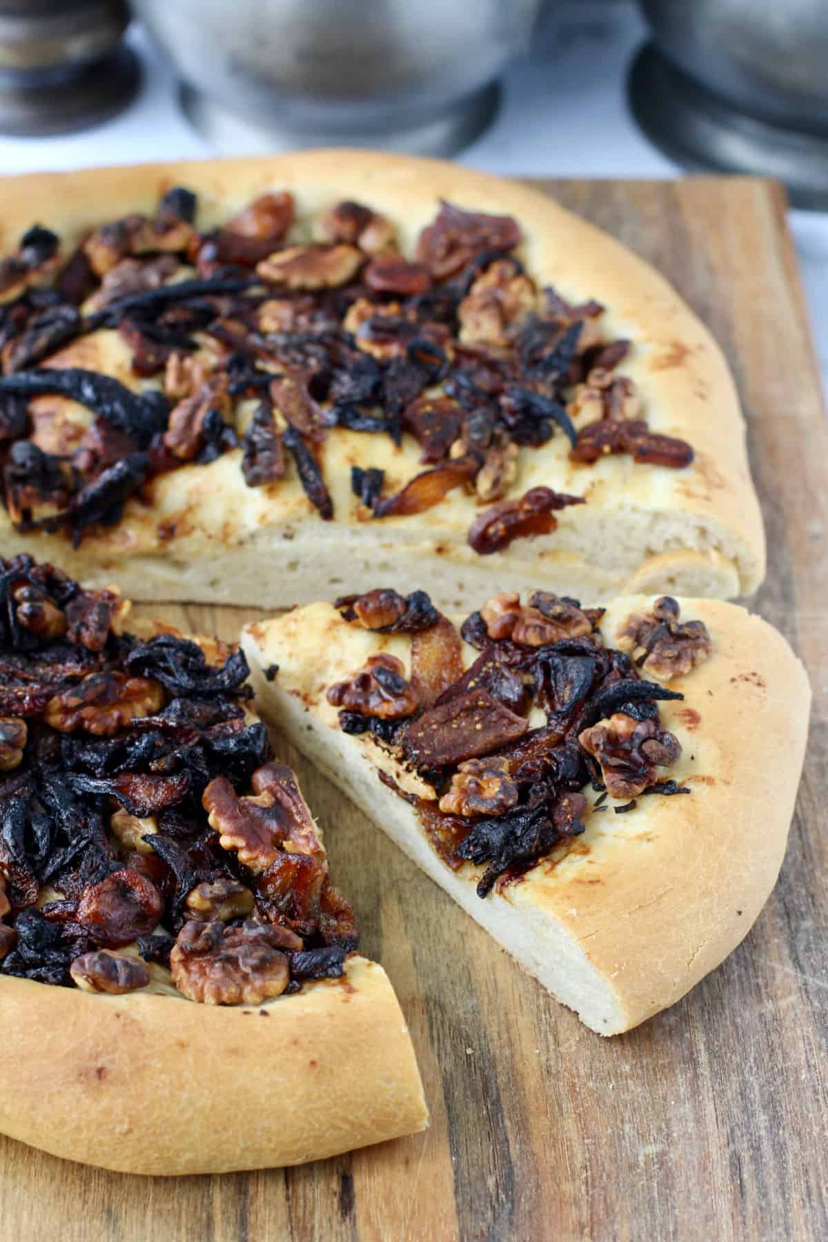 Fig and Walnut Flatbread with Caramelized Onions with one slice cut out.