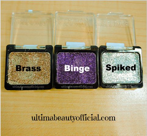Three Wet n Wild Color Icon Glitter singles opened (Gold, Purple, Silver) Text reads: Brass, Binge, Spiked