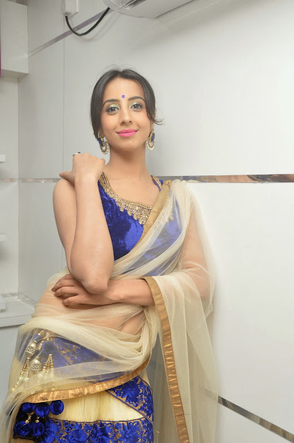 Kannada actress Sanjana posing in white sleeveless saree