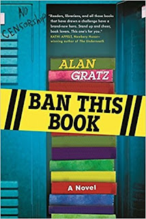 Book cover, 'Ban This Book' by Alan Gratz. Cover image depicts a stack of books inside an open, blue school locker. The locker next to it, on the left, has been graffiti-tagged 'No Censorship' 