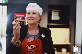Karen du Toit with decorated cupcake at Defy launch for Cupcakes of Hope