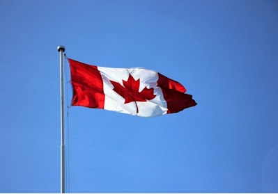 A Canadian flag on a pole