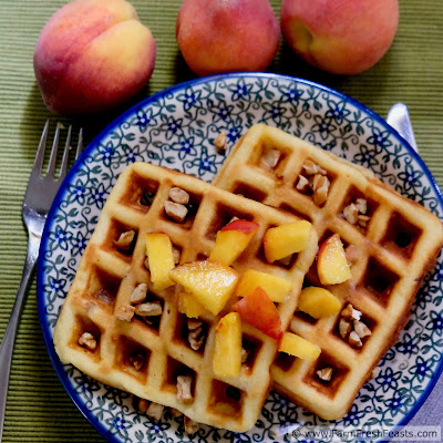 image of peach and pecan waffles topped with fresh peaches and pecans