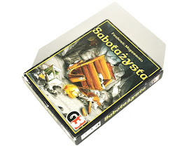 na zdjęciu pudełko gry Sabotażysta z ilustracją potłuczonego wózka górniczego i innych narzędzi oraz bryłki złota