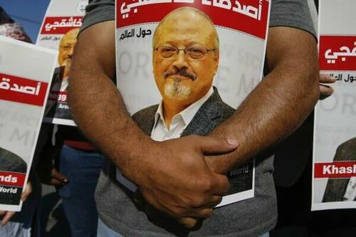 People hold posters of slain Saudi journalist Jamal Khashoggi, near the Saudi Arabia consulate in Istanbul, Turkey, on Oct. 2, 2020.