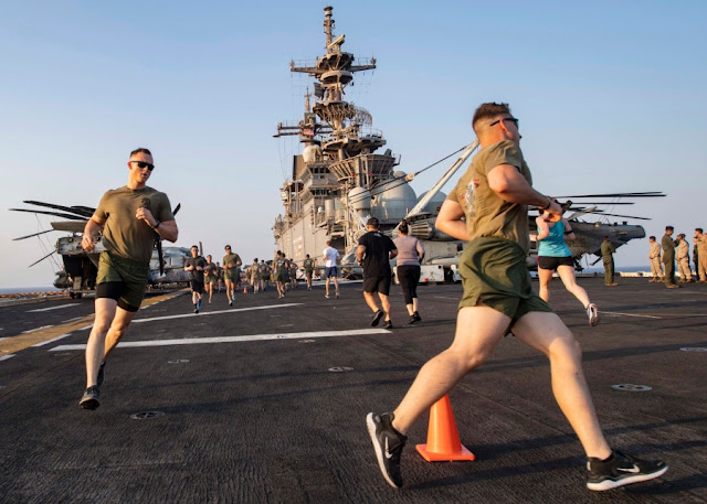 ailors and Marines aboard amphibious assault ship USS Boxer run during a Labor Day 5K held on the flight deck during exercise Eager Lion in the Red Sea, Sept. 1, 2019.