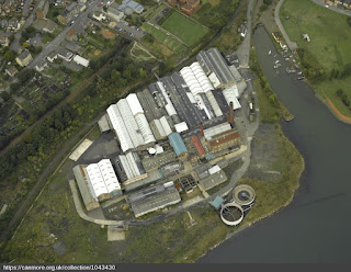 Oblique aerial view centred on the paper mill and saltworks, taken from the SSE. https://canmore.org.uk/collection/1043430