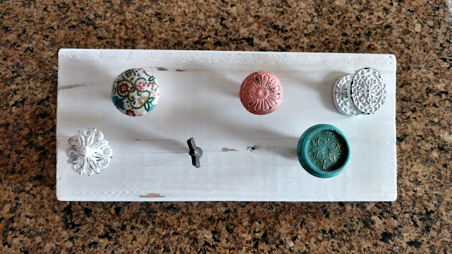 Make your own hanging necklace holder using a piece of scrap wood and some cute drawer knobs!