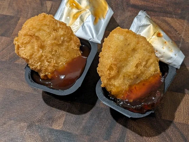 McDonald's Chicken McNuggets dipped in Mambo Sauce and Sweet & Spicy Jam.