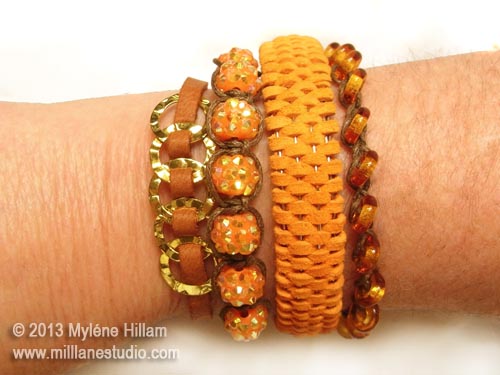 Bangle stack of 4 bangles and bracelets including gold rings woven with tan lace, shamballa beads and twine, orange peel domed woven leather bangle and transparent glass donut beads on woven beading cord.
