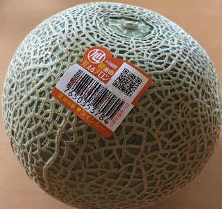 A whole Quincy melon with a QR code sticker 