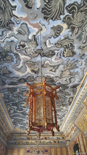 Beautiful lanterns hung from the ceilings. The ceilings were painted with pictures of dragons playing in swirling clouds, Thien Dinh Palace. Tomb of Khai Dinh..